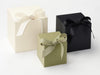 Three Softbox Large gift boxes in Ivory, Sage Green, and Black with ribbons on a white background