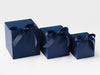 Three navy blue soft box gift boxes with ribbons on a white background
