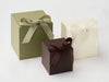 Three softbox gift boxes in Sage green, Dark Chocolate brown, and Ivory with ribbons on a white background
