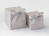 Two cloud gray softbox gift boxes with ribbons on a white background