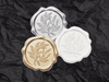 Silver, Gold and White Wax Seals Featured on Black Tissue Paper