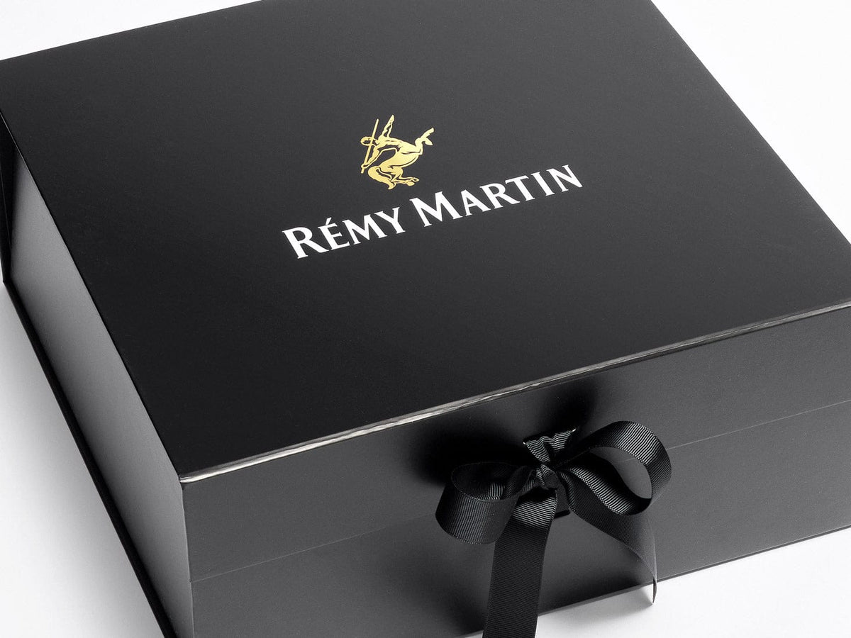 Rémy Martin Gold and White Foiled Logo on Black XL Deep Gift Box with a bow on a white background