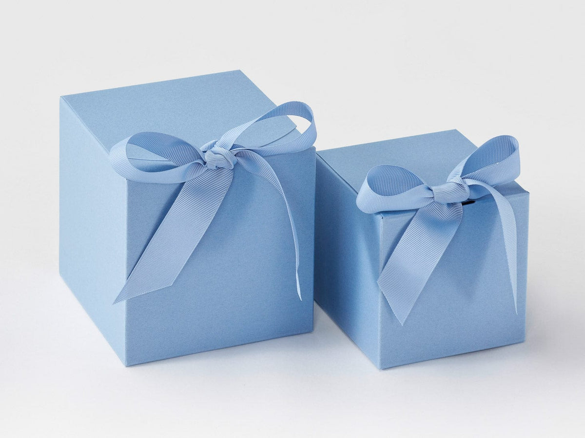 Two dusky blue soft boxes gift boxes with ribbons on a white background