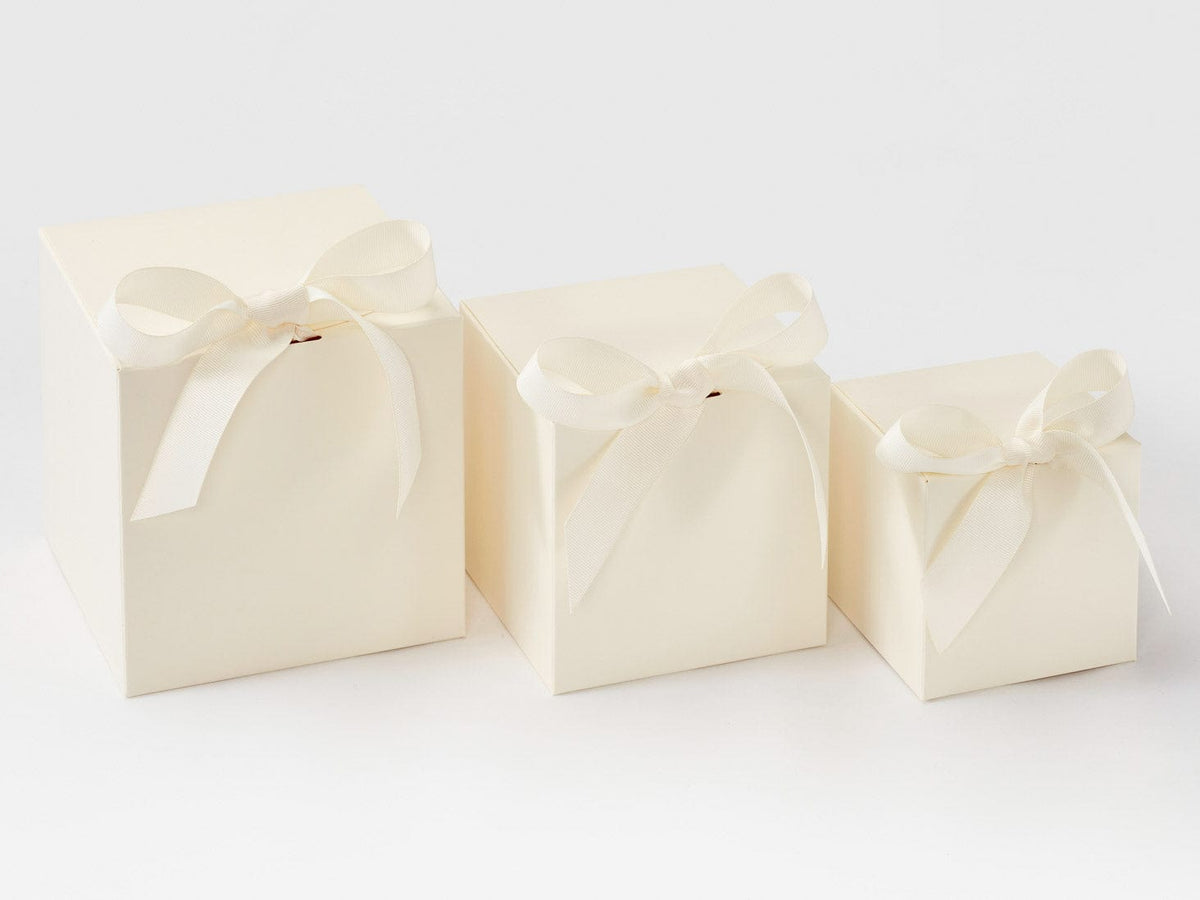 Three Ivory-colored softbox gift boxes with ribbons on a white background