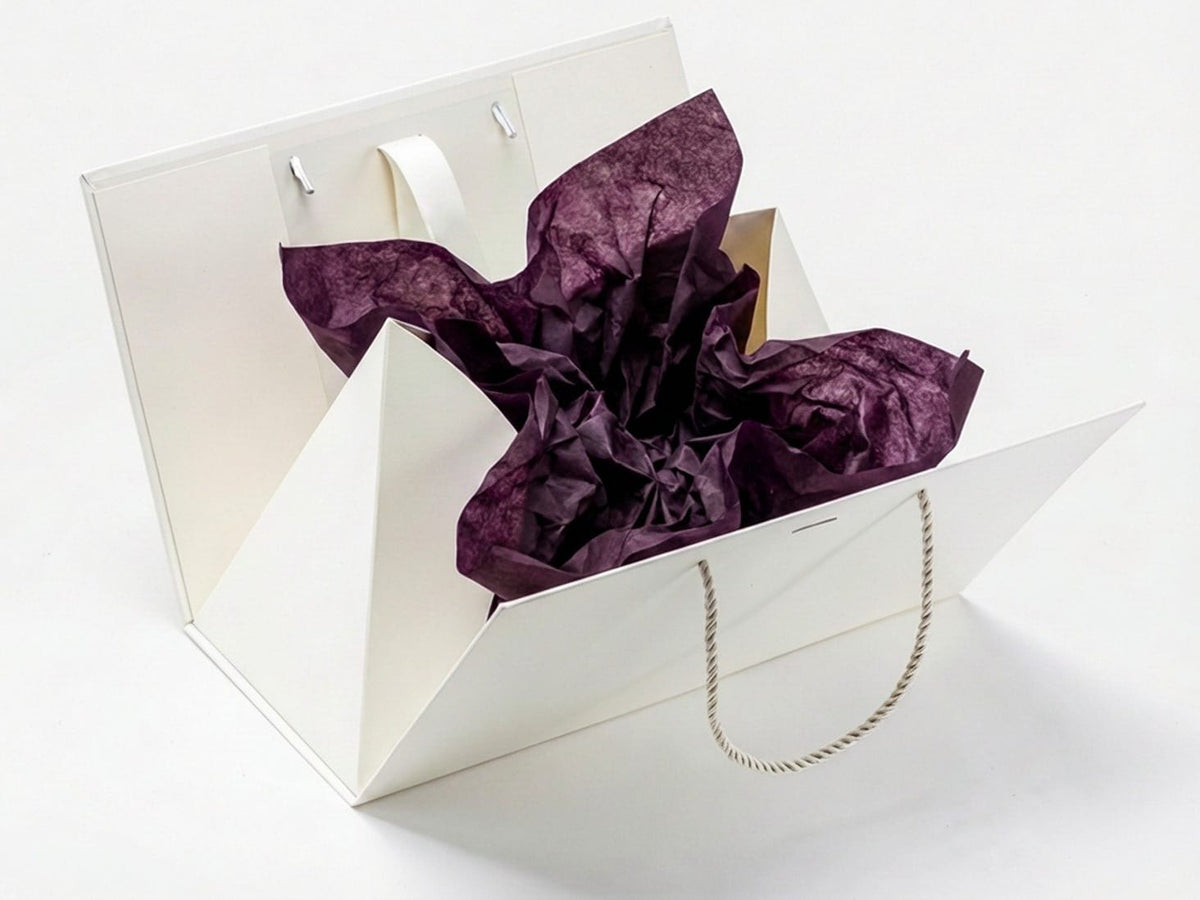 Ivory Boxbag with purple tissue paper on a white background