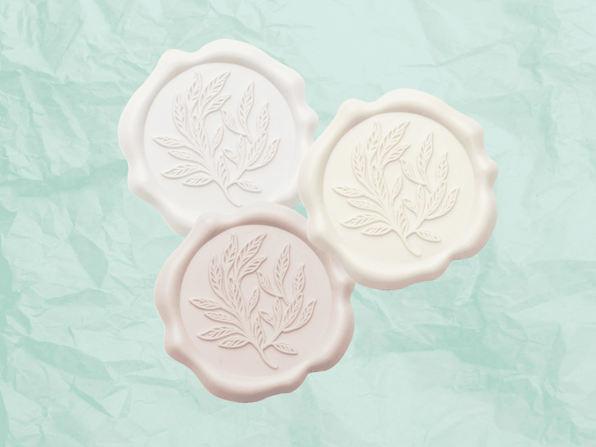 Ivory, Pale Pink and White Wax Seals and Mint Green Tissue Paper work well with Aqua Ribbon