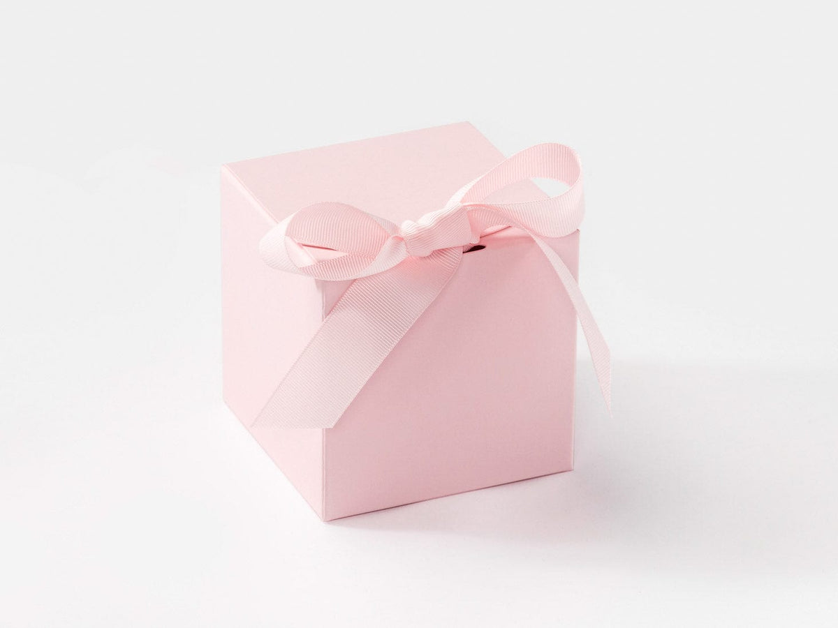 Pink gift box with a bow on a white background