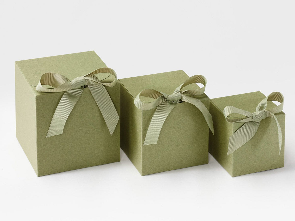 Three green soft box gift boxes with ribbons on a white background