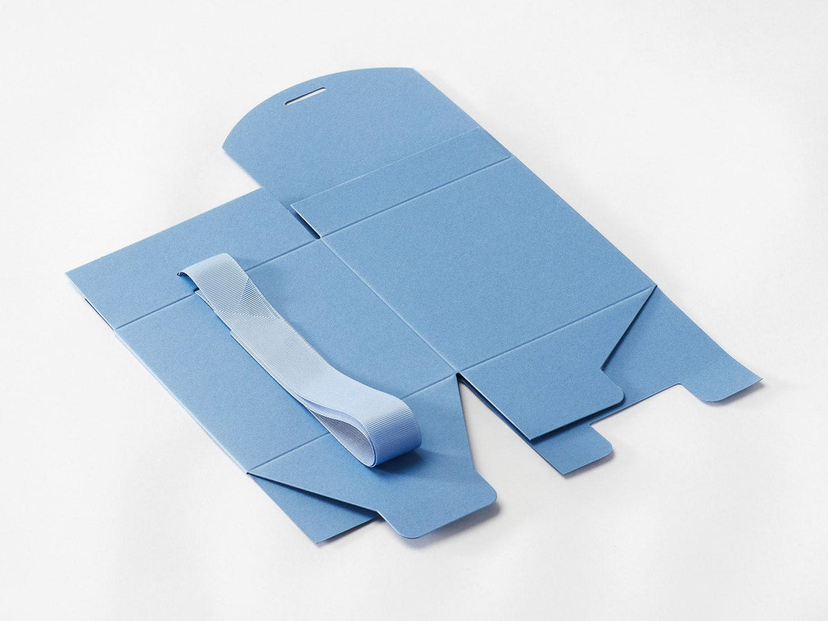 Dusky blue large soft boxes with ribbons on a white background