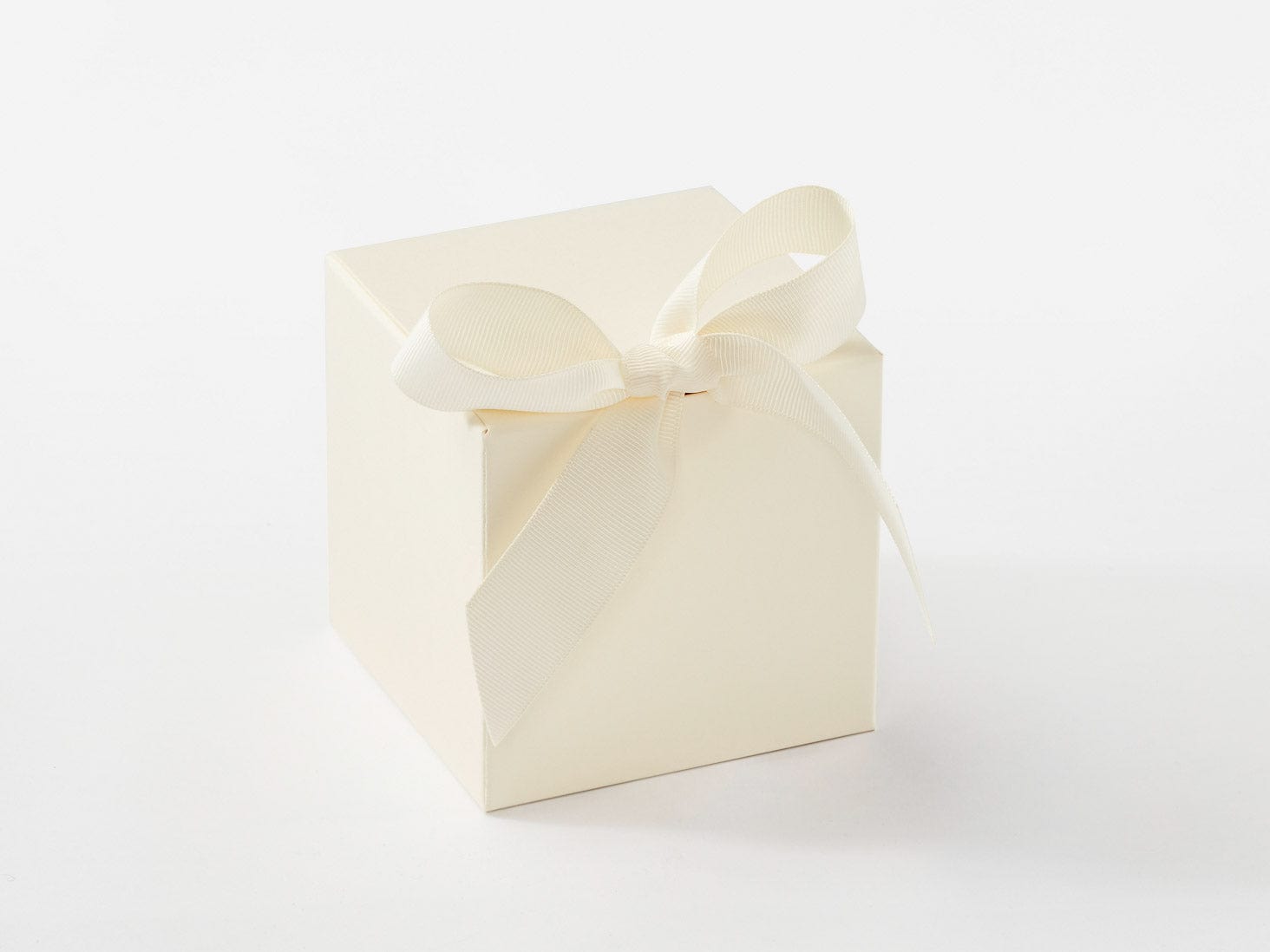 Ivory gift box with a bow on a white background