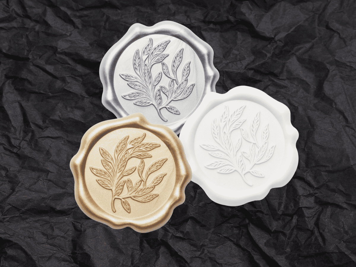 Silver, Gold and White Wax Seals Featured on Black Tissue Paper