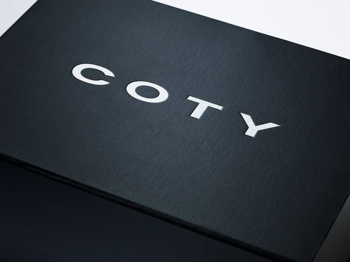 Black Folding Gift Box with Custom Printed White Coty Logo to Lid